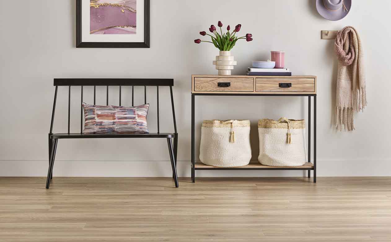 Laminate floors in hallway with bench and table